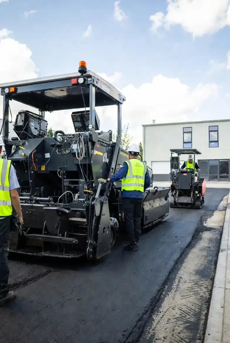Oak Hill Asphalt Contractor Crew Asphalt crew in safety vests operating a paver on a commercial paving job