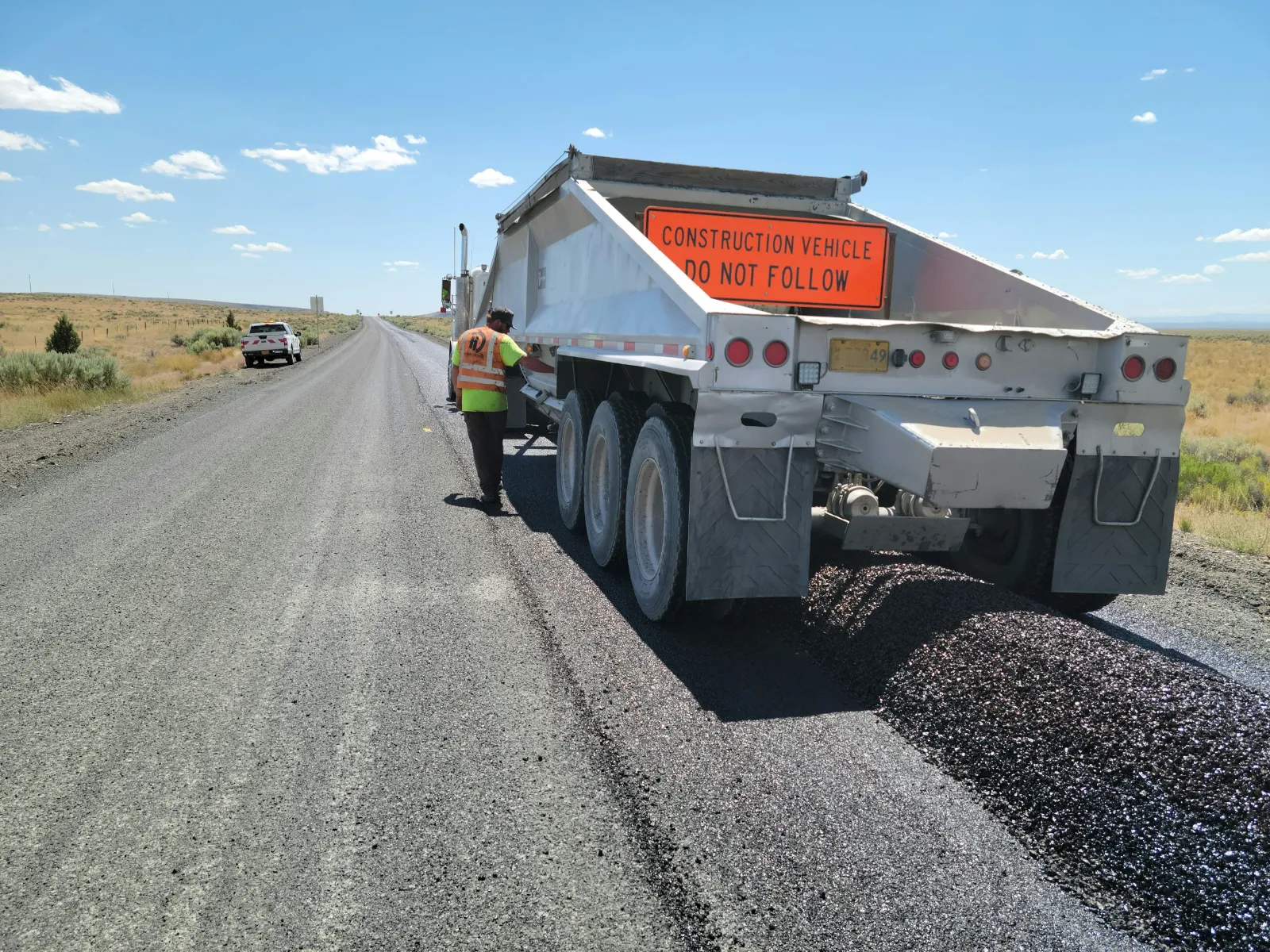 Heavy dump truck hauling material on an asphalt road - heavy industrial traffic
